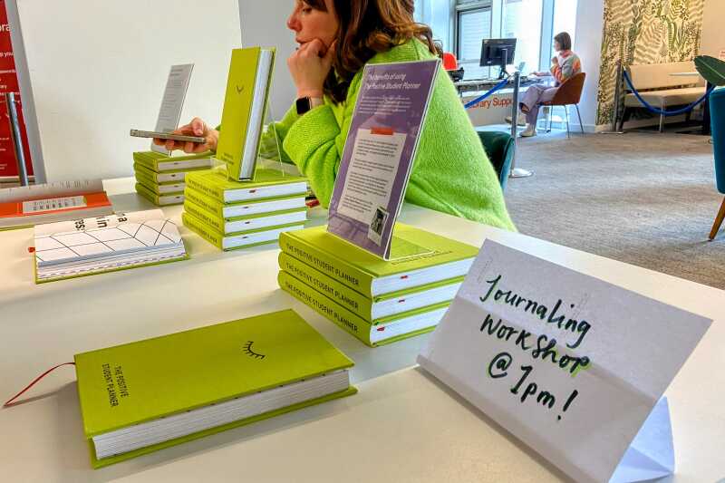 Wellbeing journals and a sign promoting a workshop