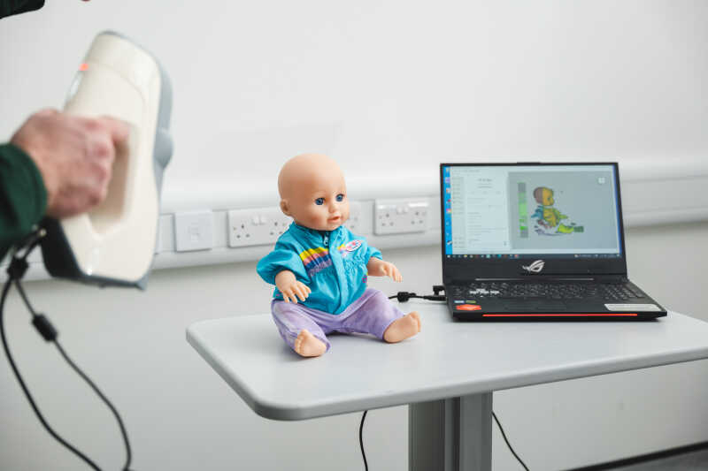 An electronic baby is used in an experiment in the child development unit.