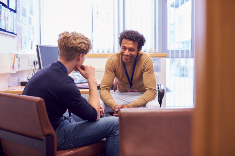 Student in meeting with adviser in their office.