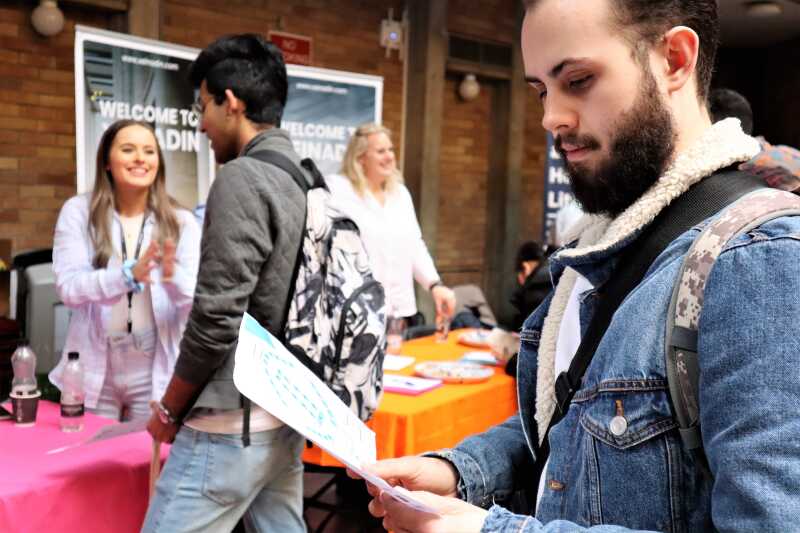 A student at a career fair looks at a career map.