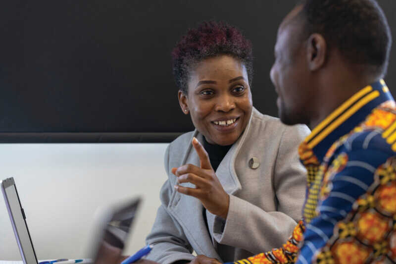 Two postgraduate researchers having a conversation