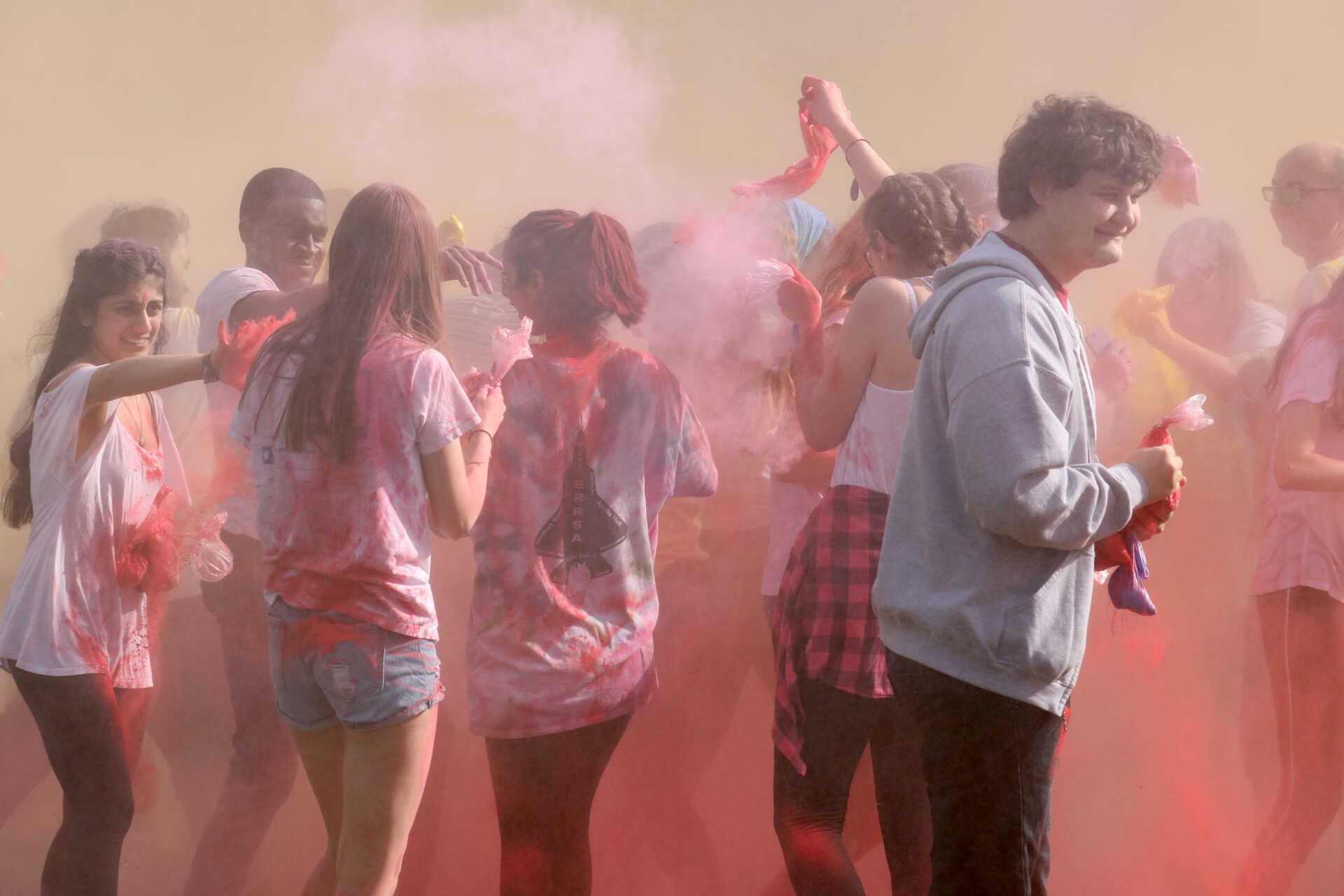 Students celebrating Holi with coloured powder