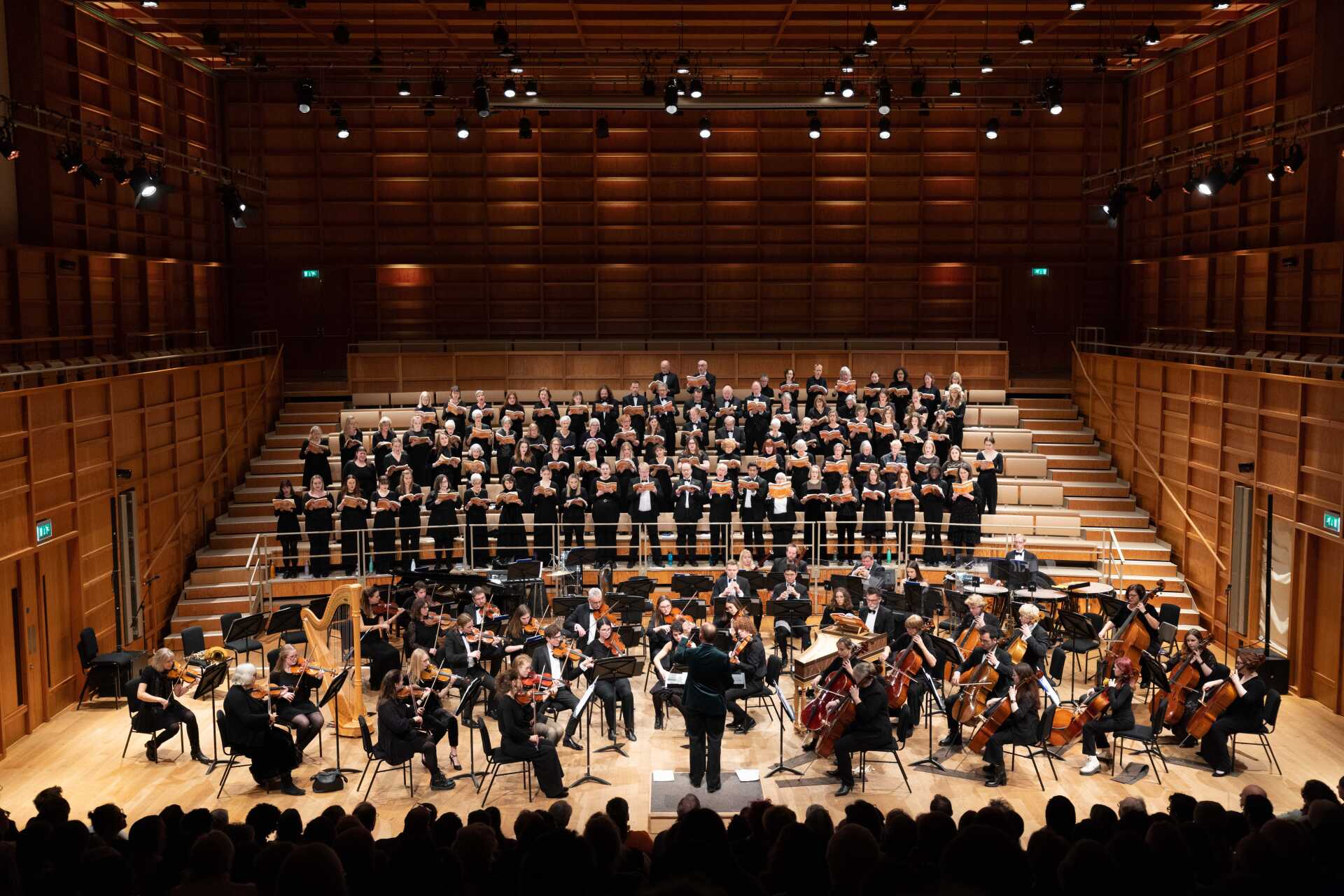 Choir and orchestra performing in a concert-hall