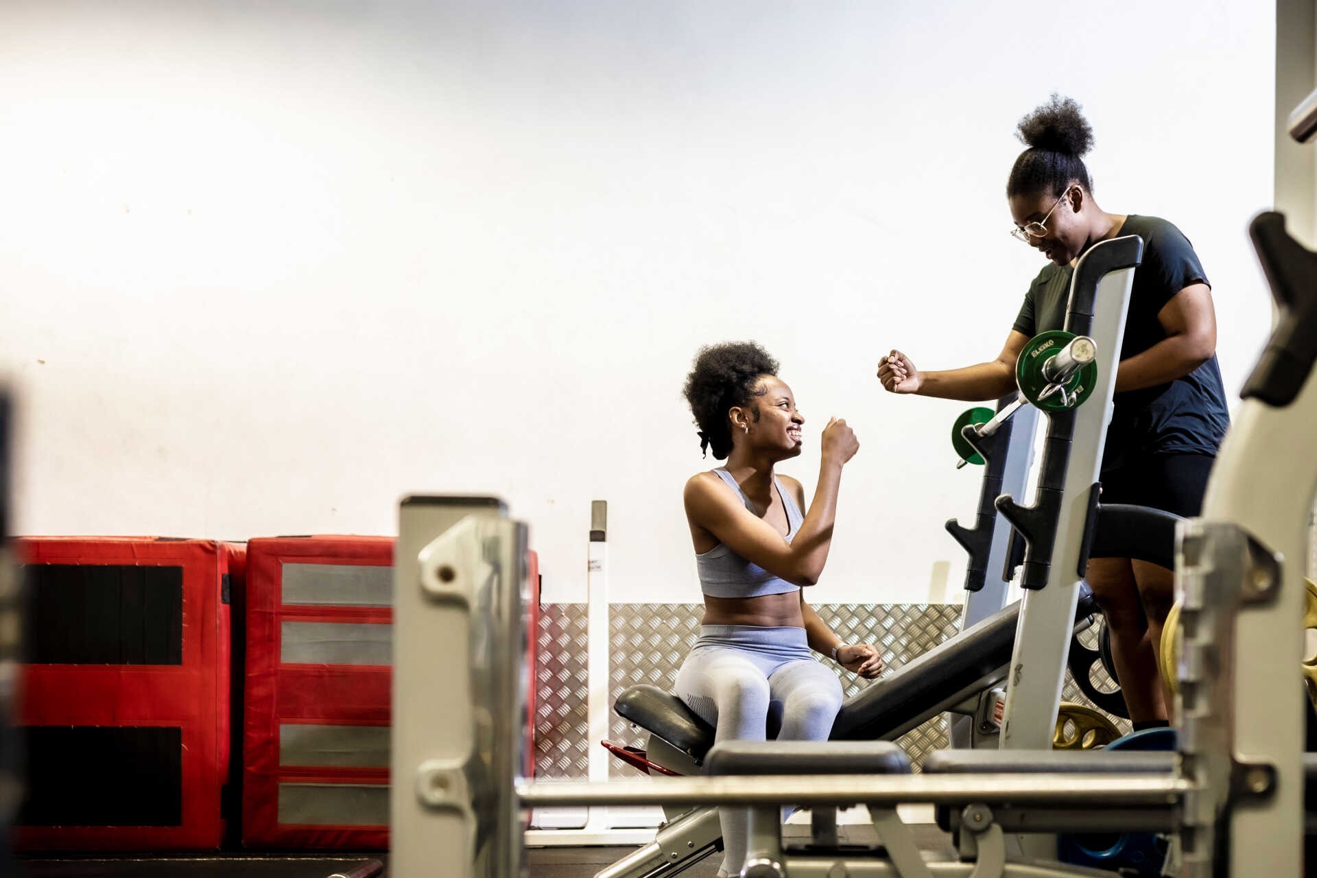 Two students fist bumping at the gym.
