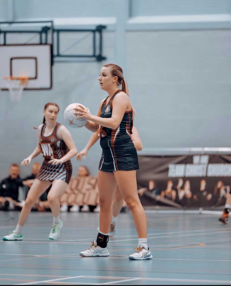 Emily taking a centre pass on court