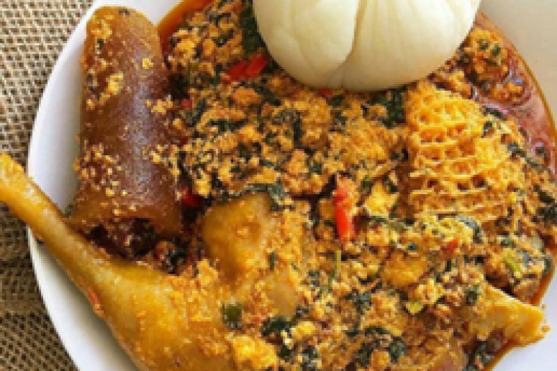 Image shows a bowl of Nigerian Fufu and Fgusi soup