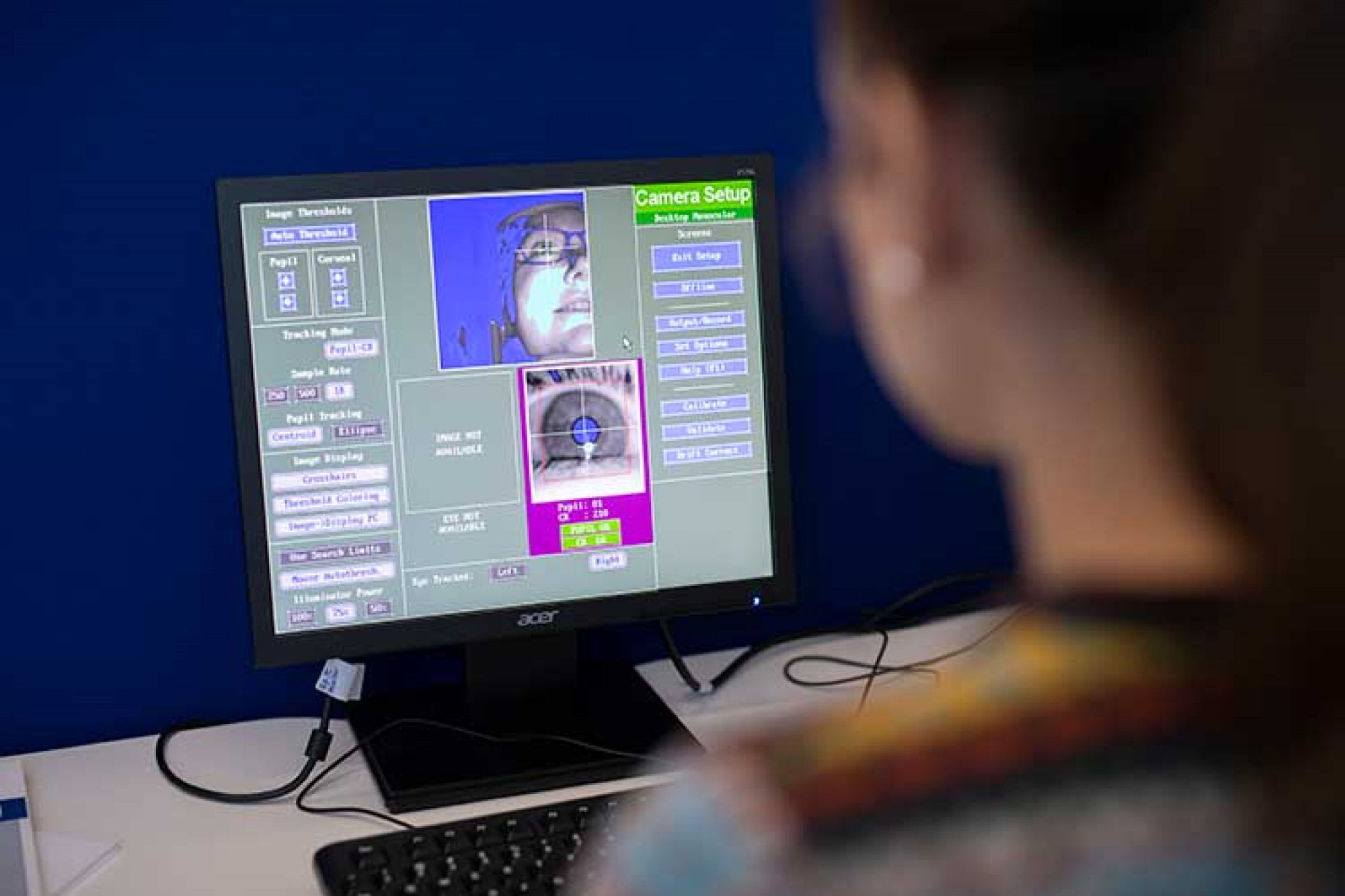 Close-up image of a computer screen with images of an eye and face to demonstrate the use of eye-tracking software