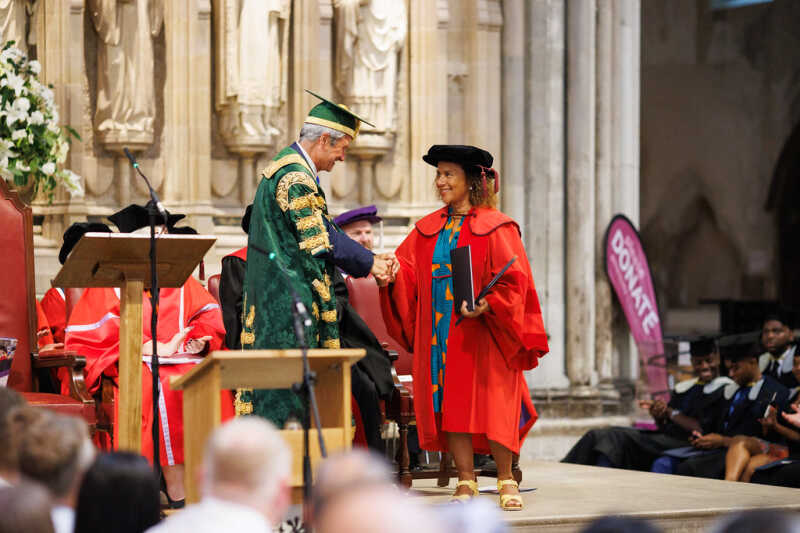 Chi-chi accepting her award from Chancellor Gavin Esler