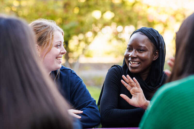 University of Kent students sitting and chatting.