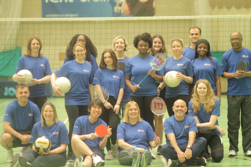 Group of student and staff with sports equipment wearing ALL Active t shirts