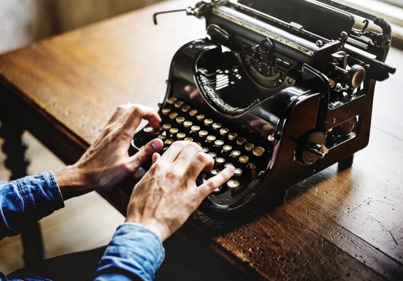 Hands on old-fashioned typewriter