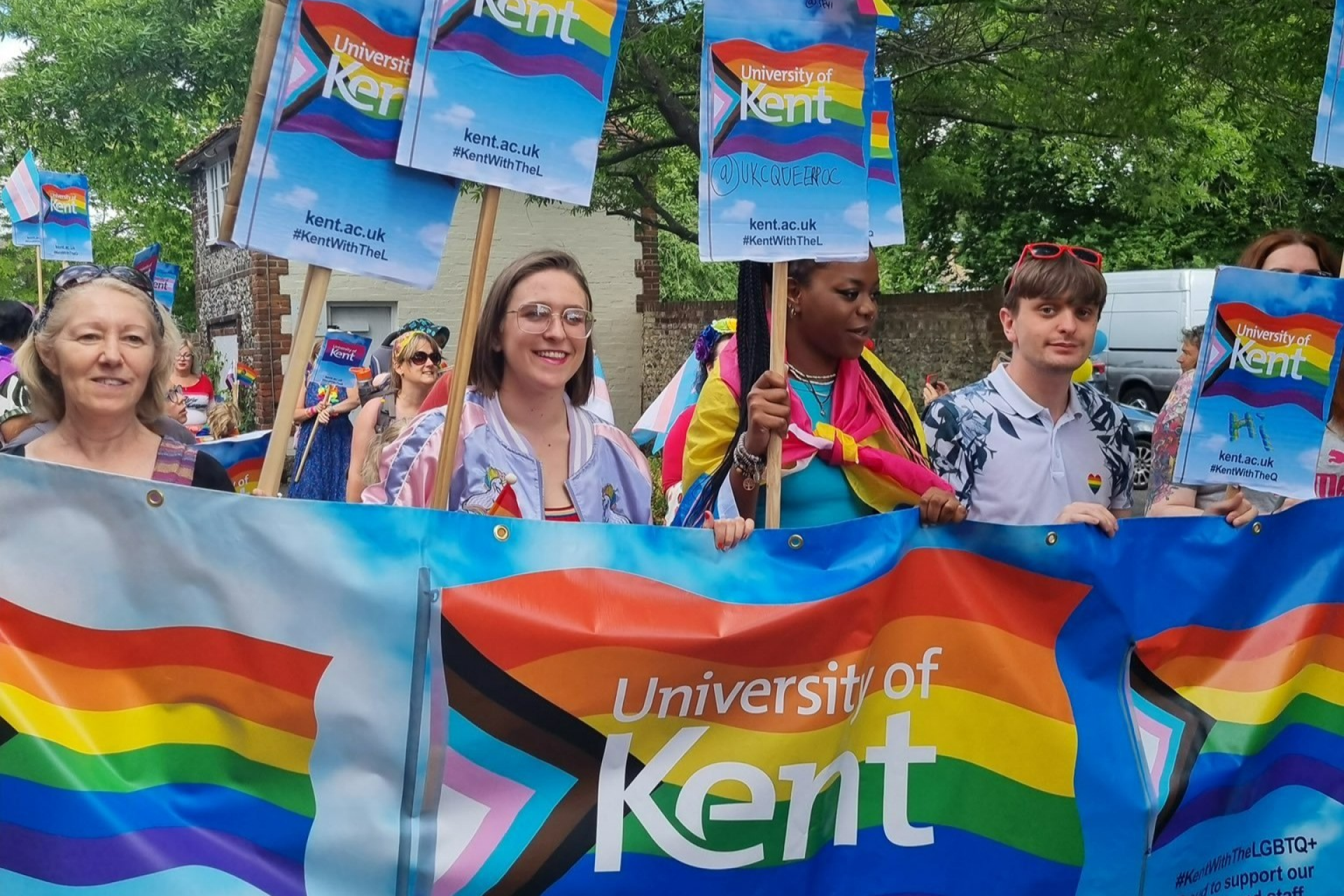 Image shows Kent staff and students holding Pride banners