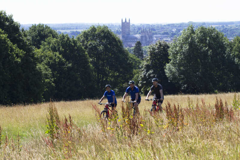 Cycling on campus wit Cathedral in distance