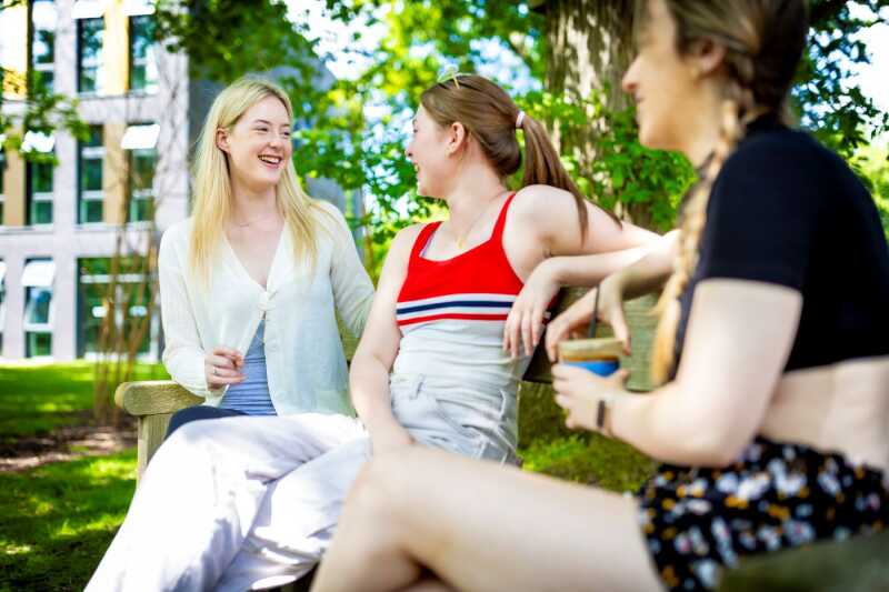 Students chatting on bench