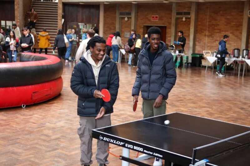 Two students playing table tennis