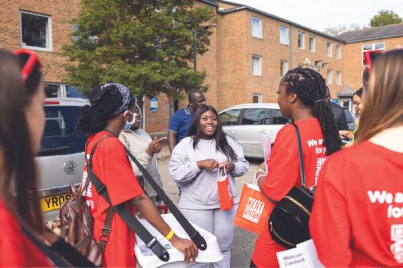 A group of students welcoming a student to the University