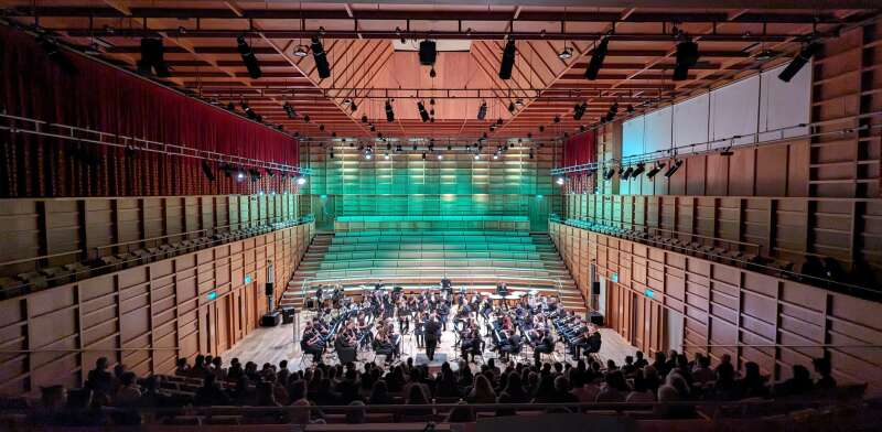 Group of musicians performing in a concert hall