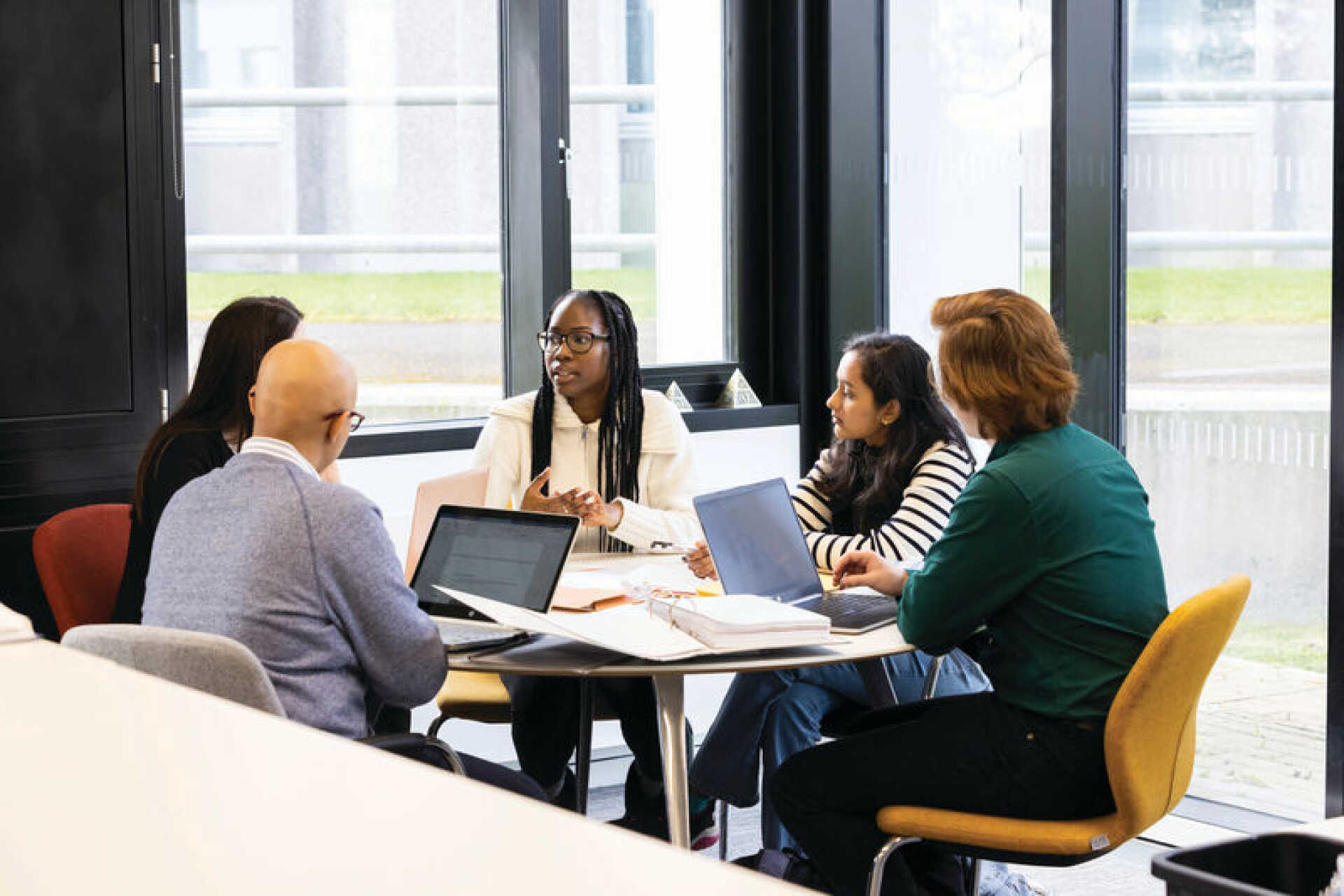 University of Kent students studying at a desk.