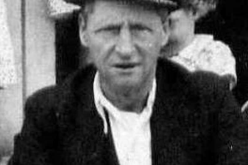 Black and white photograph of a white male, Cephas Thorpe, a miner. He is wearing a white shirt, black jacket and a flat cap.