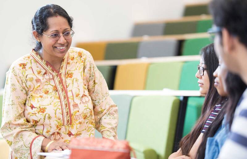 Lecturer with students in lecture hall