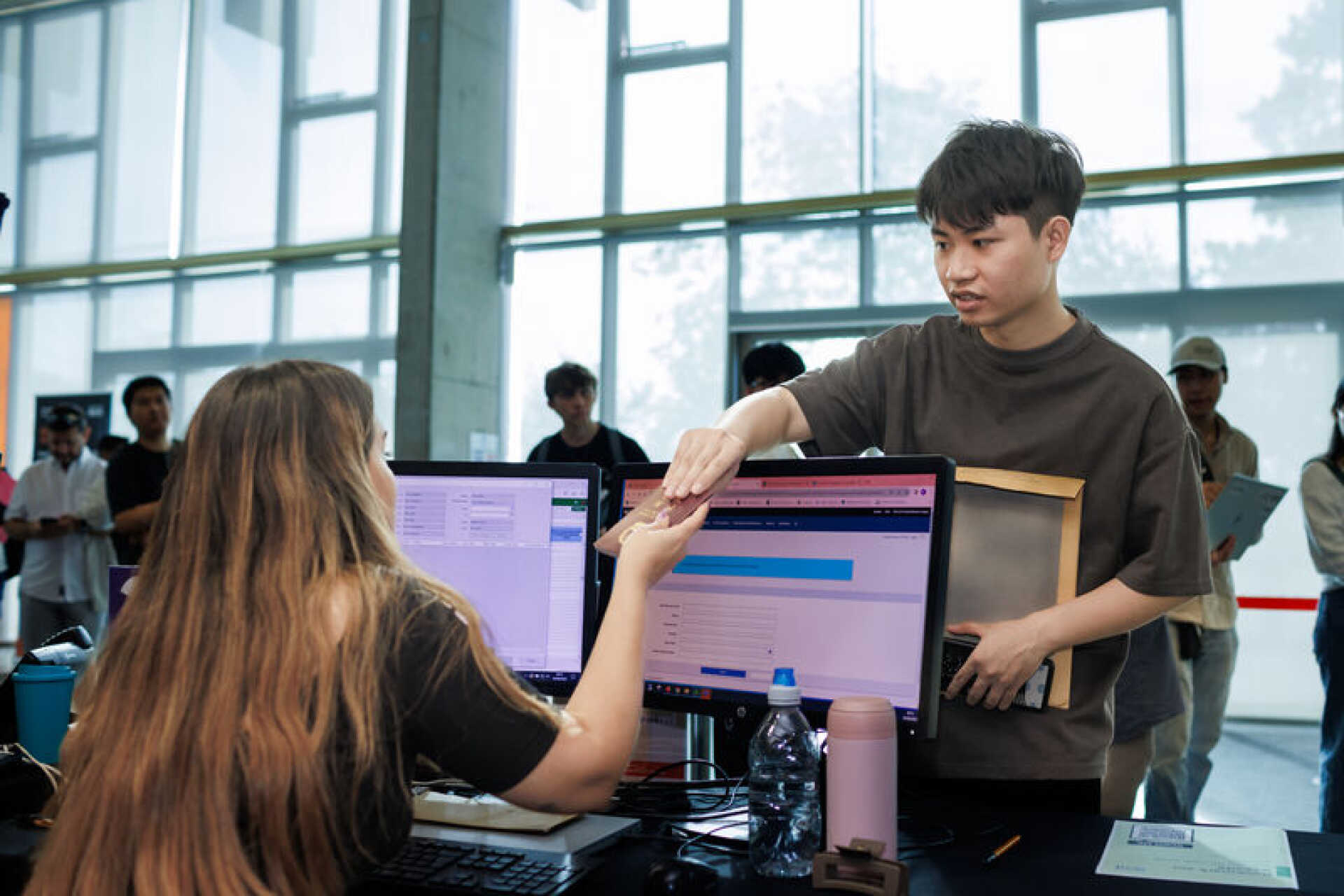 A University of Kent student talking to a member of staff.