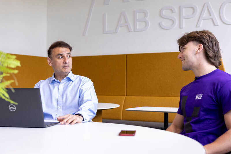 A student and member of staff in conversation.