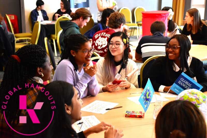 Students chatting around a table at a Global Hangout