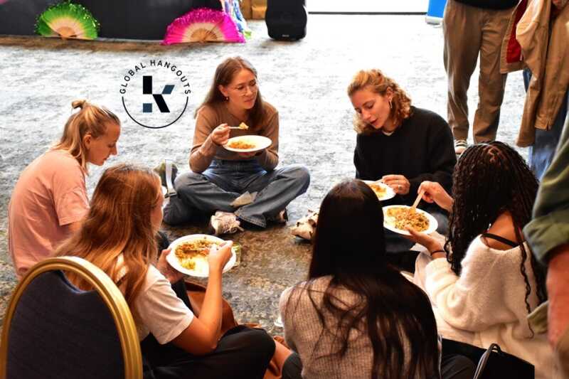 Students sitting on the floor, eating