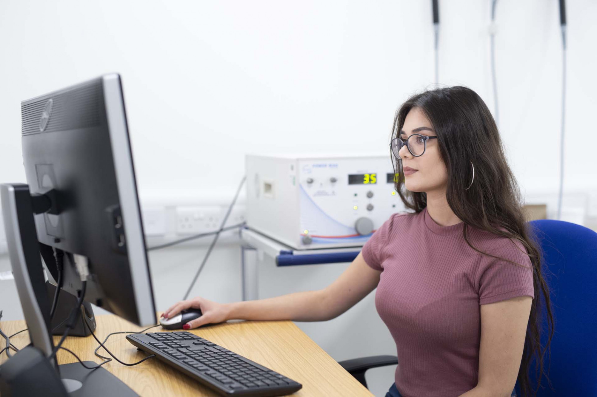 Student working at a computer in the TMS laboratory