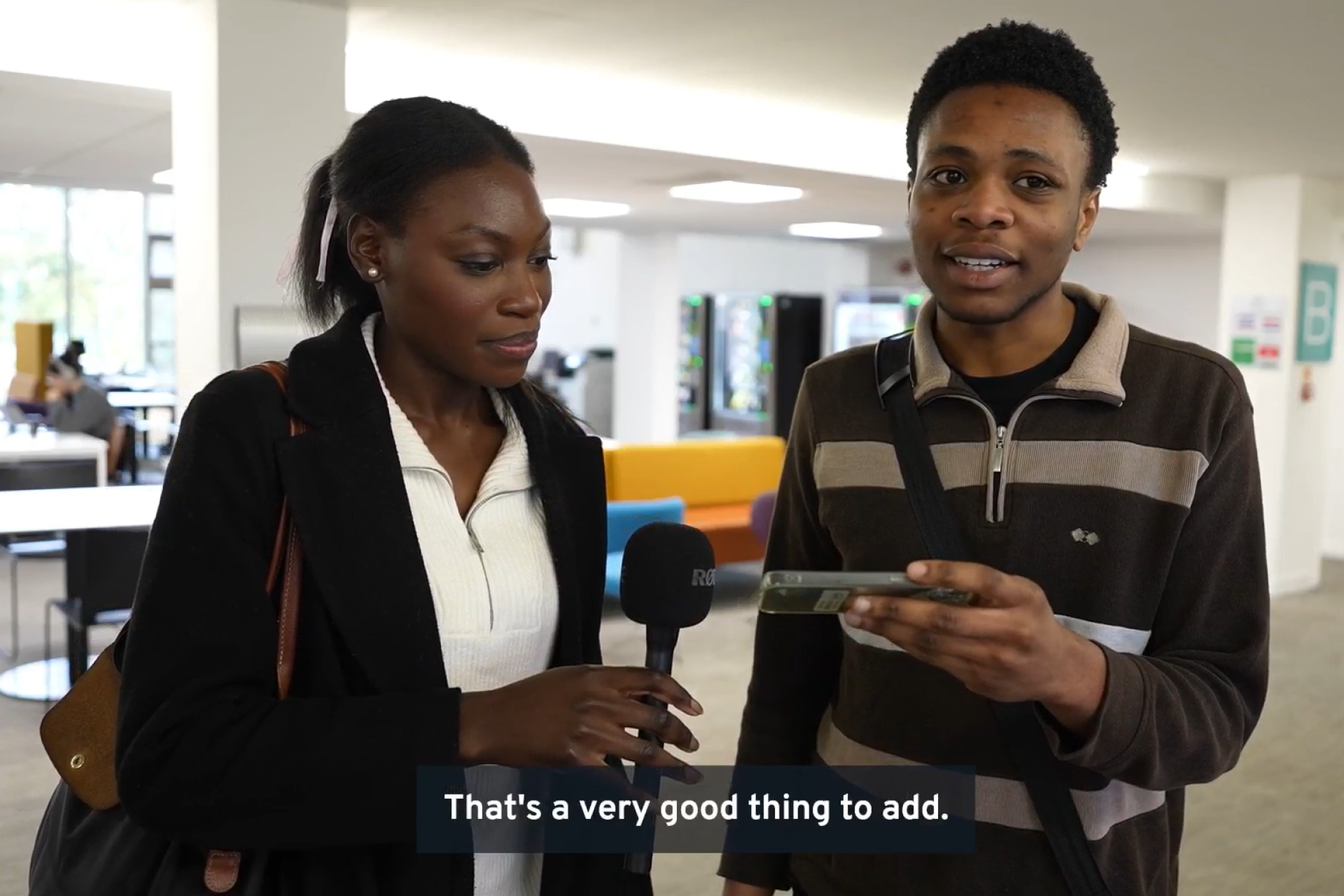 young black woman with a thoughtful face holding a microphone and young black man looking directly at camera