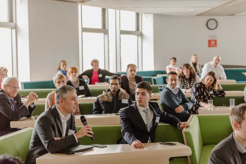 People in a seminar room having a conference