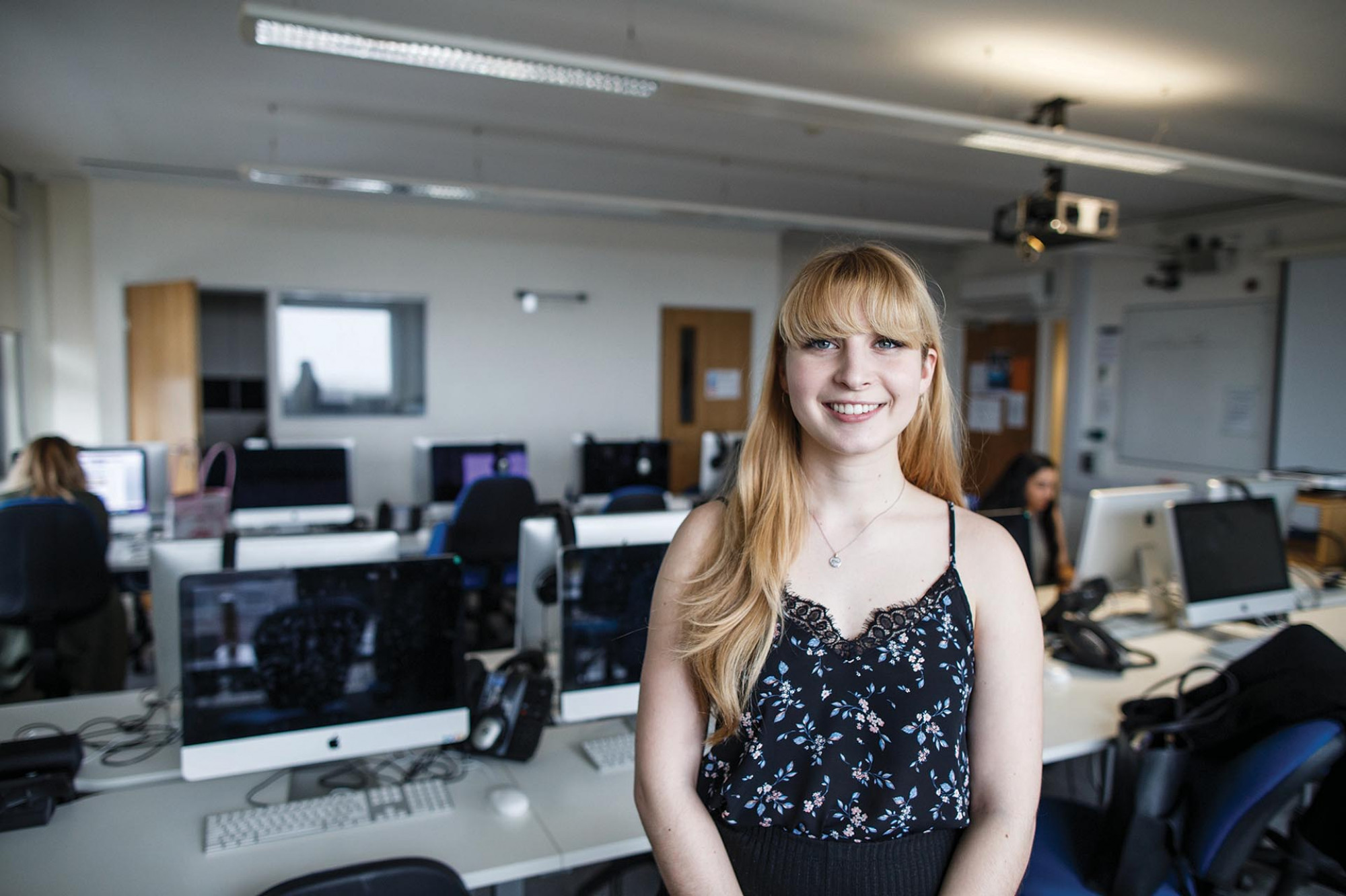 A smiling student, picture in the Centre's newsroom