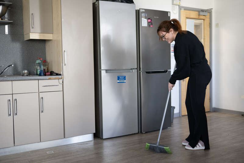 Students sweeping the kitchen floor