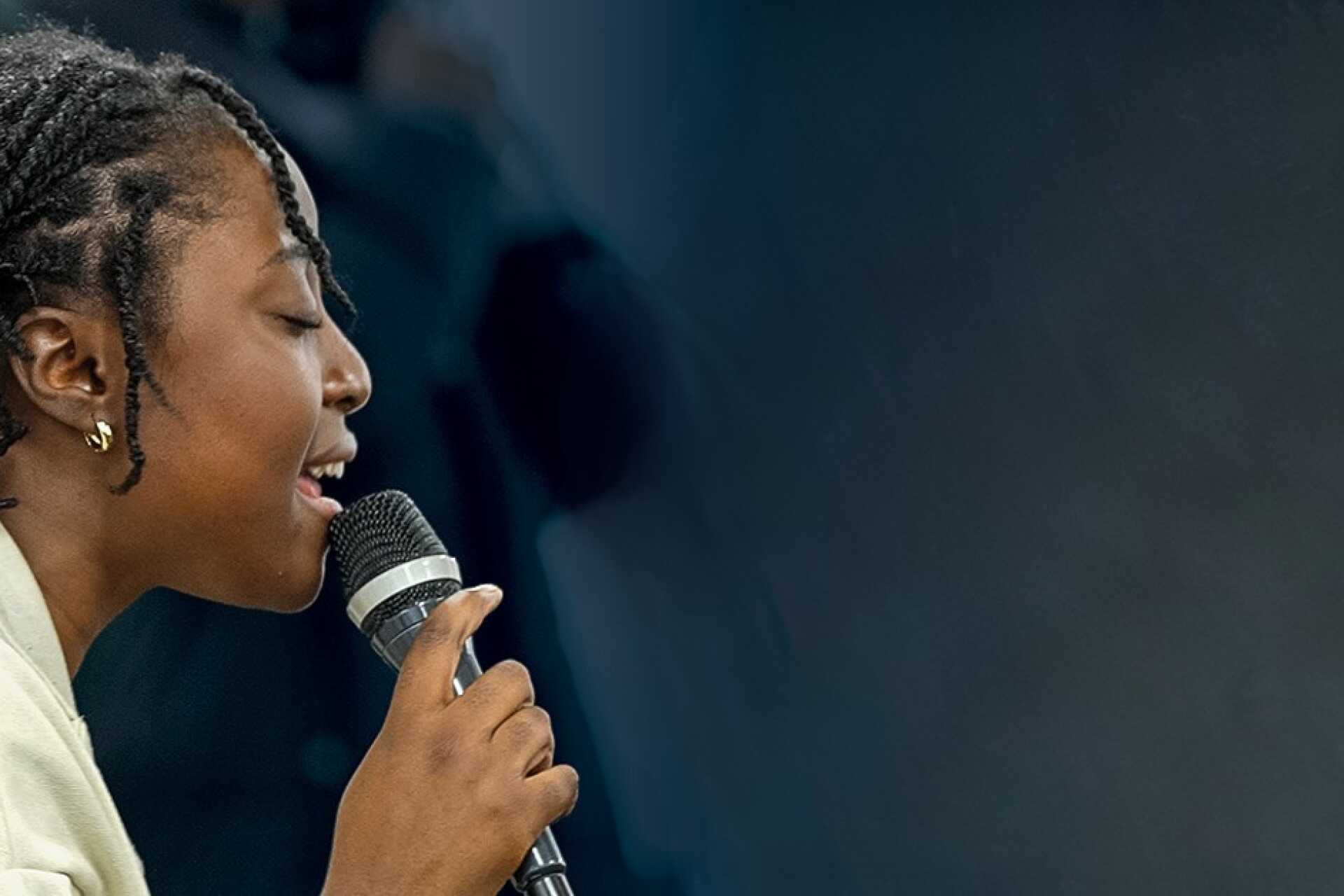 student singing into microphone
