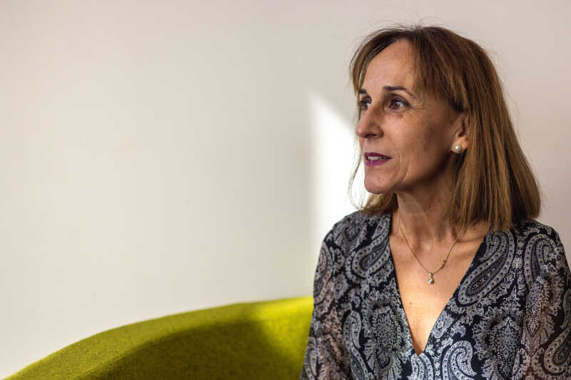 Image shows a woman smiling