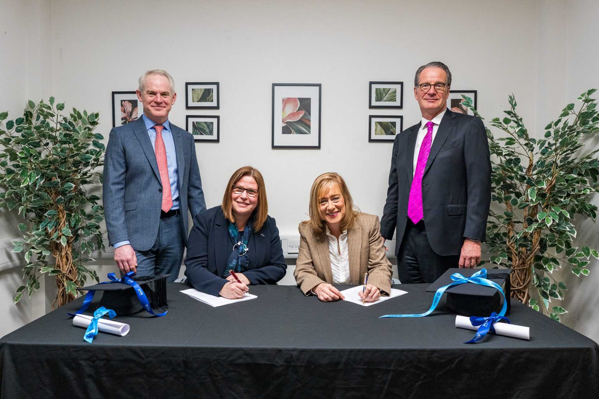 Vice-Chancellors of Kent and Greenwich signing merger contract