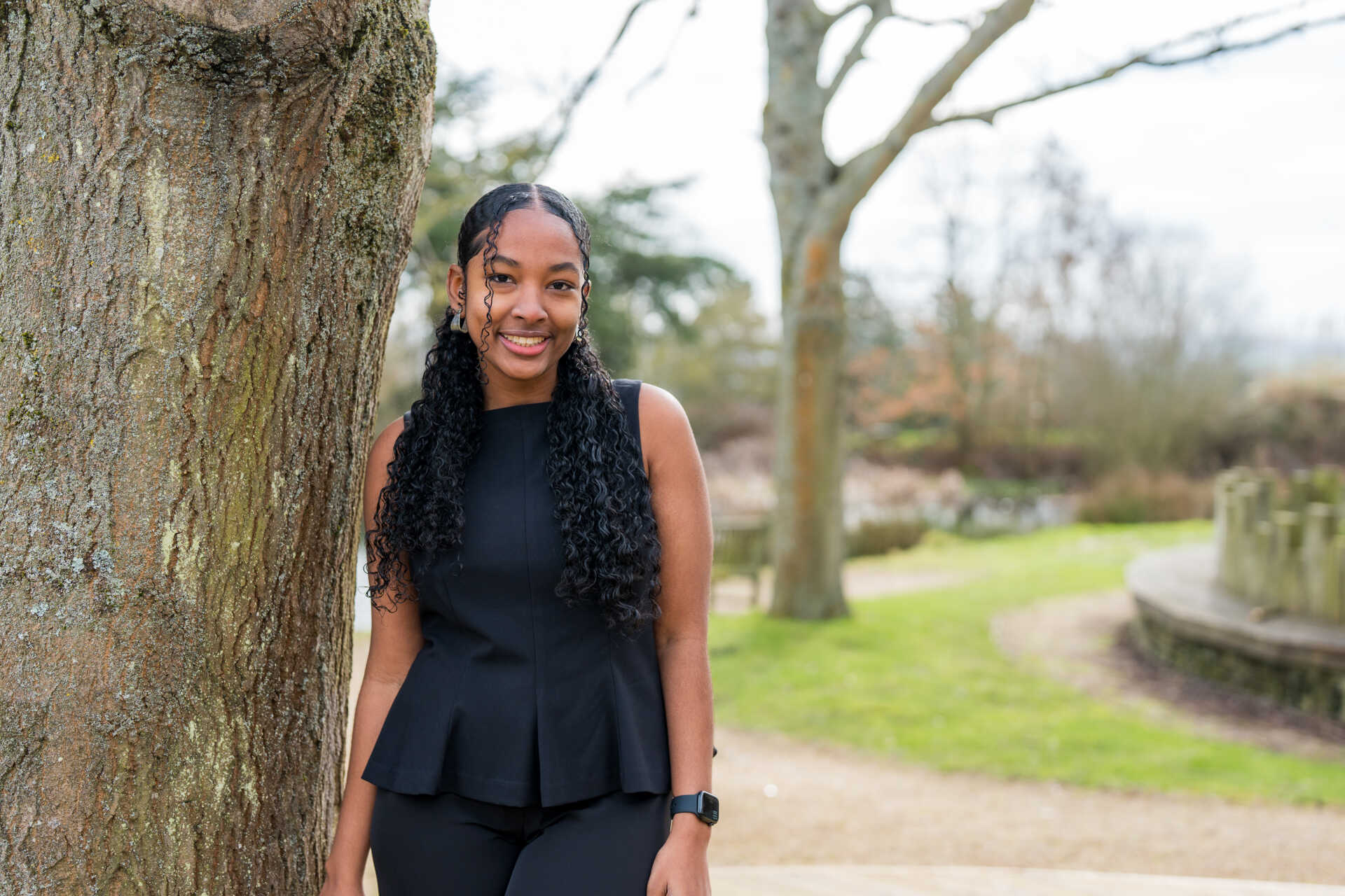 Kerriva smiling outside by tree