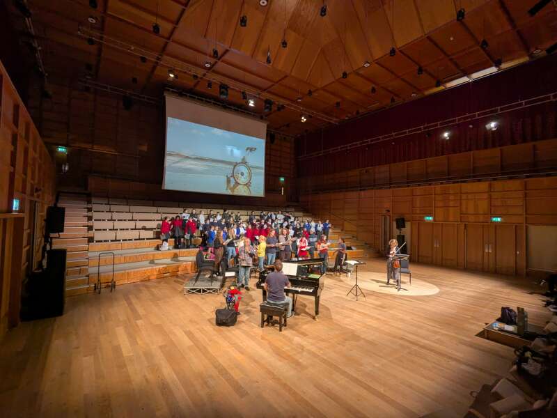 Group of singers and insturmentalists rehearsing in a concert-hall