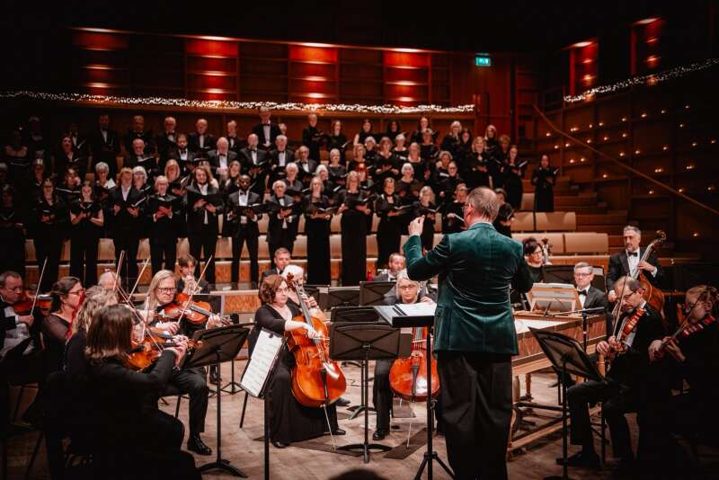 Orchestra and choir performing in a concert-hall