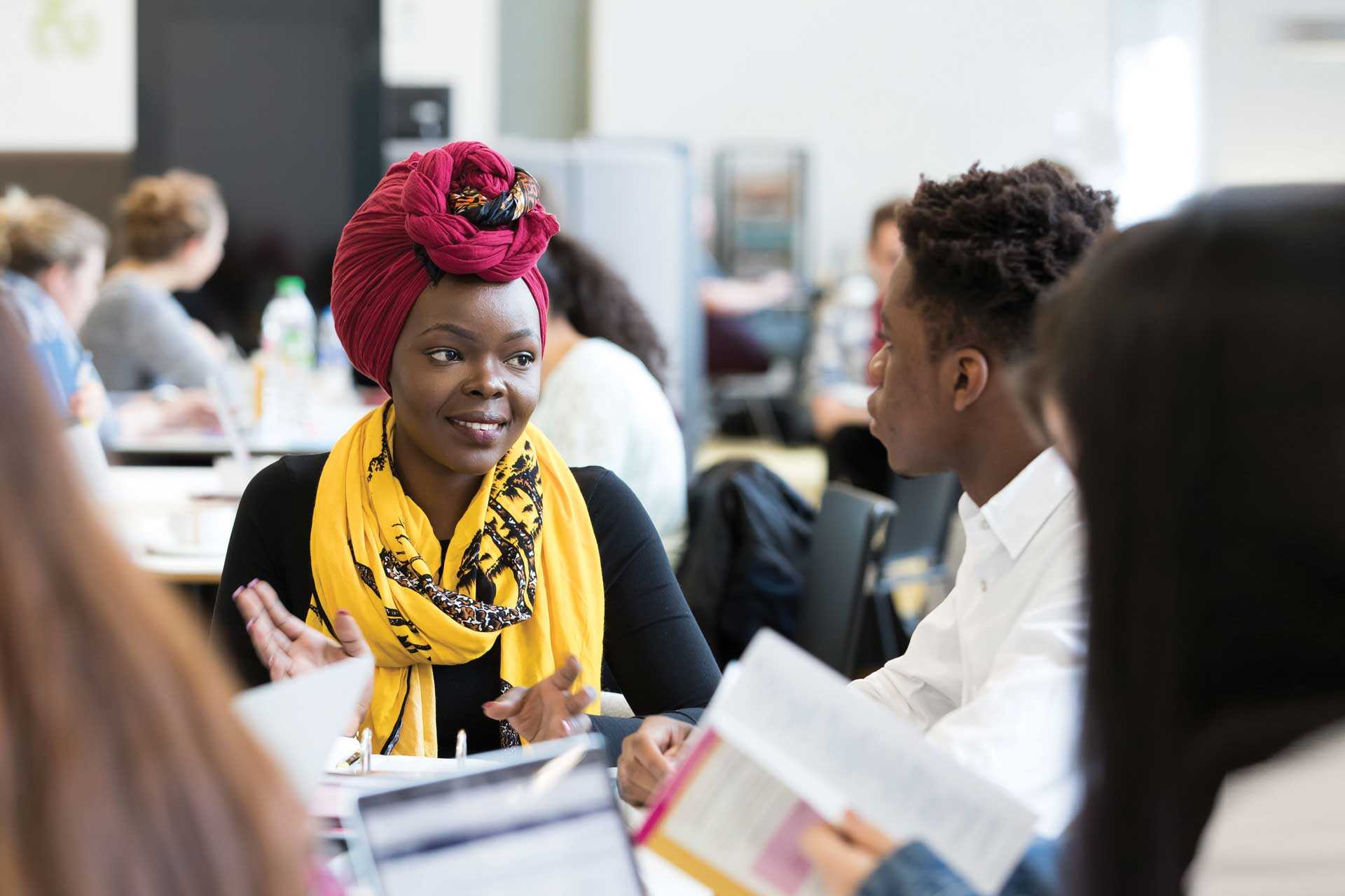 Students chatting in a busy social space