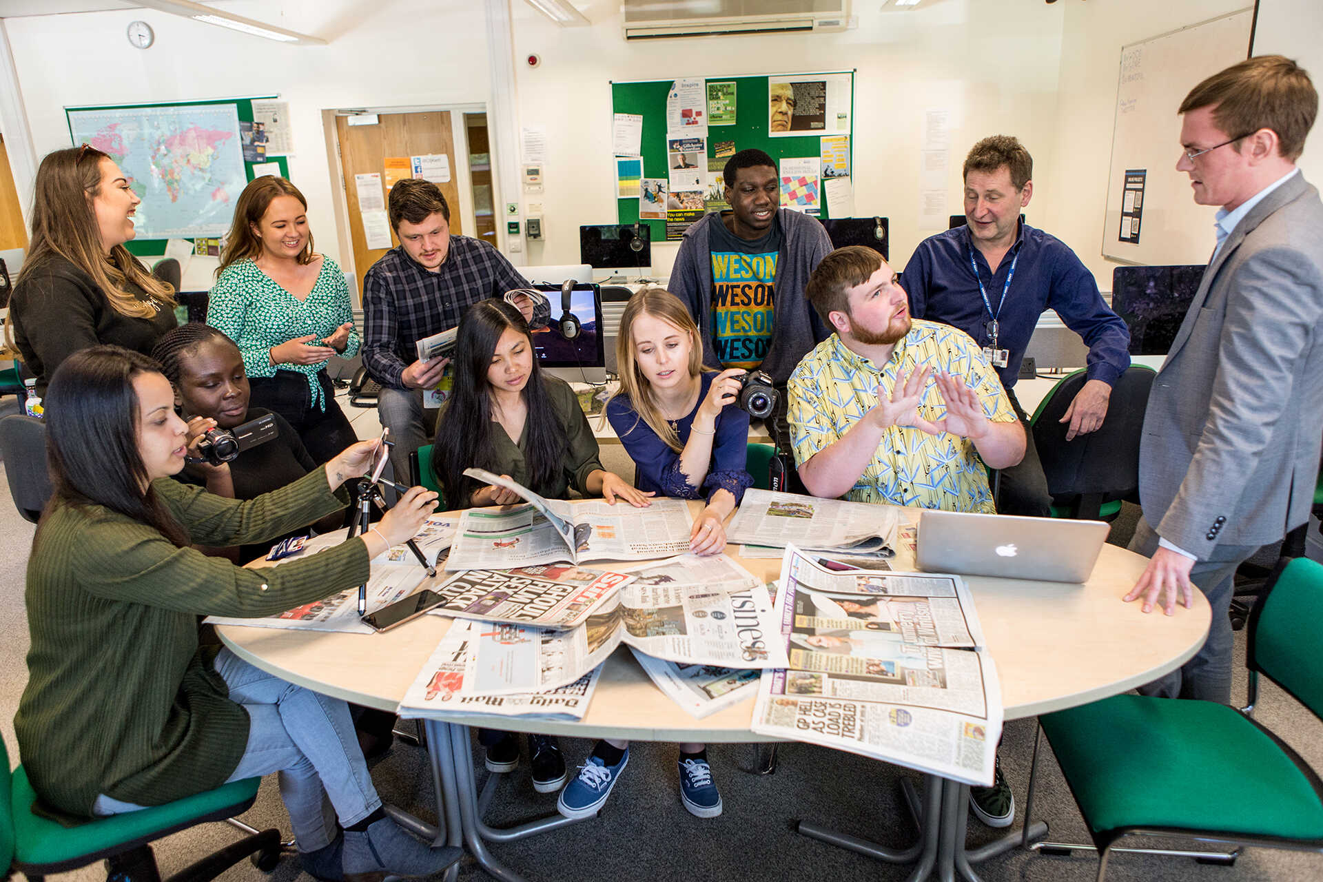 Students sitting around the newsdesk