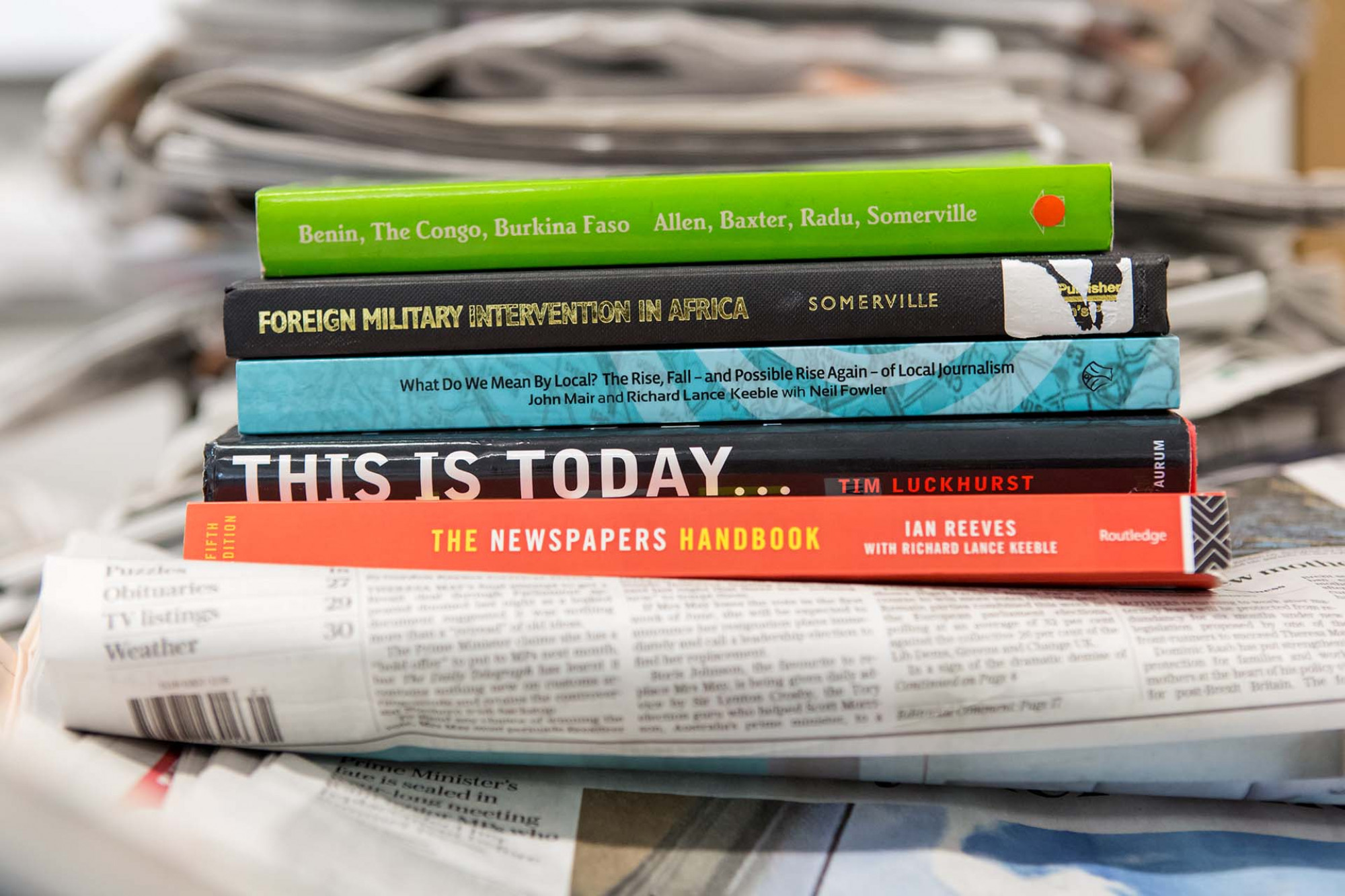 Stack of books about journalism written by Centre for Journalism staff members