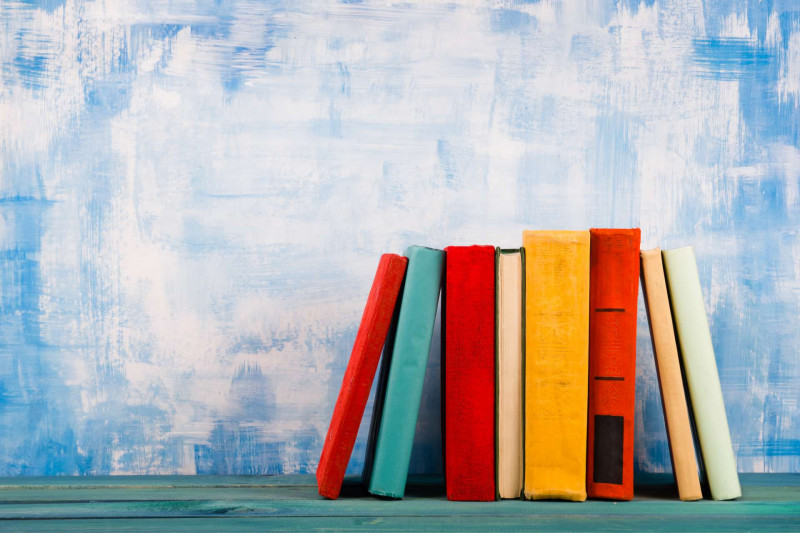 colourful books against a blue background