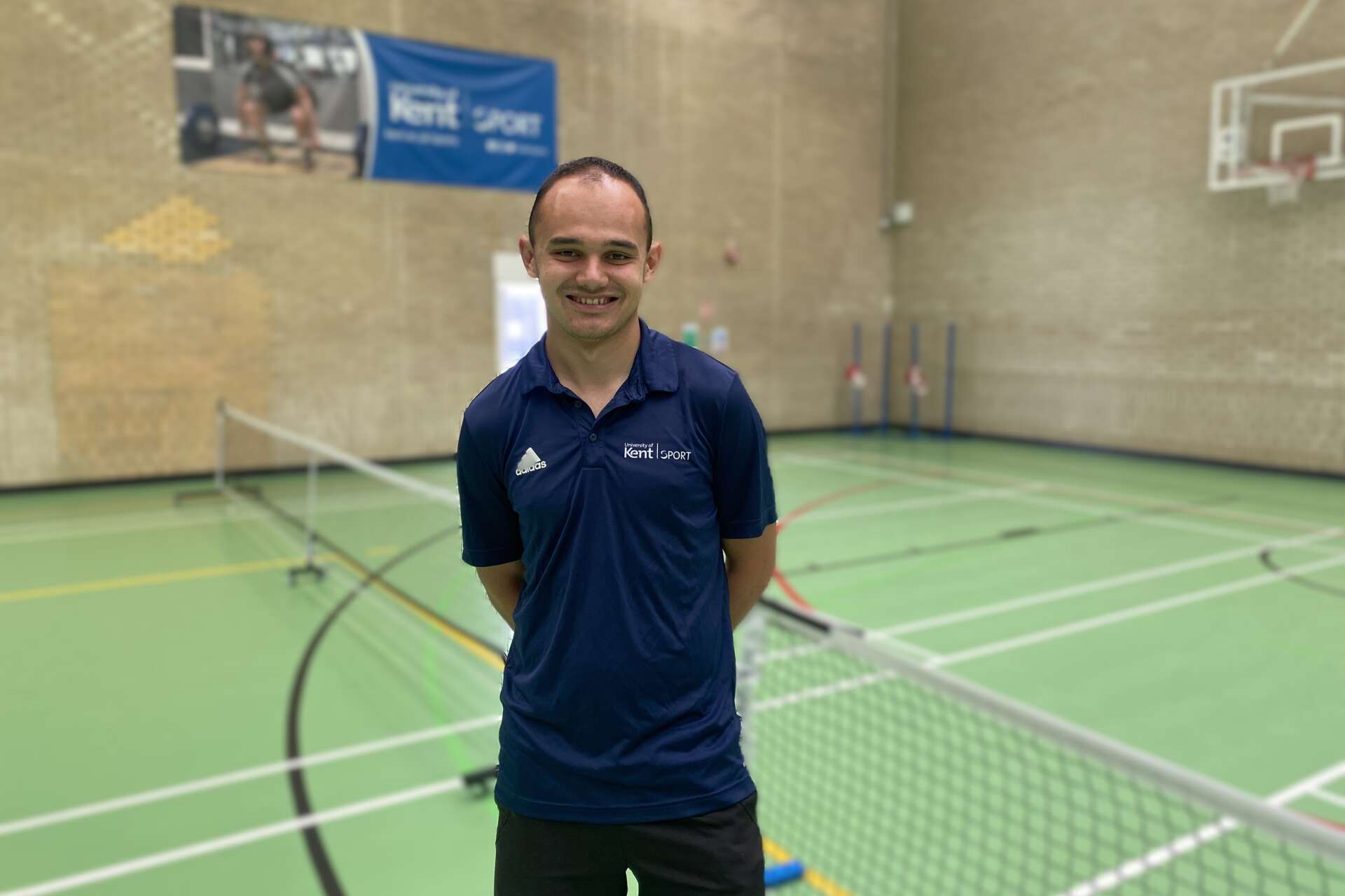 Sam Stephens smiling in sports hall