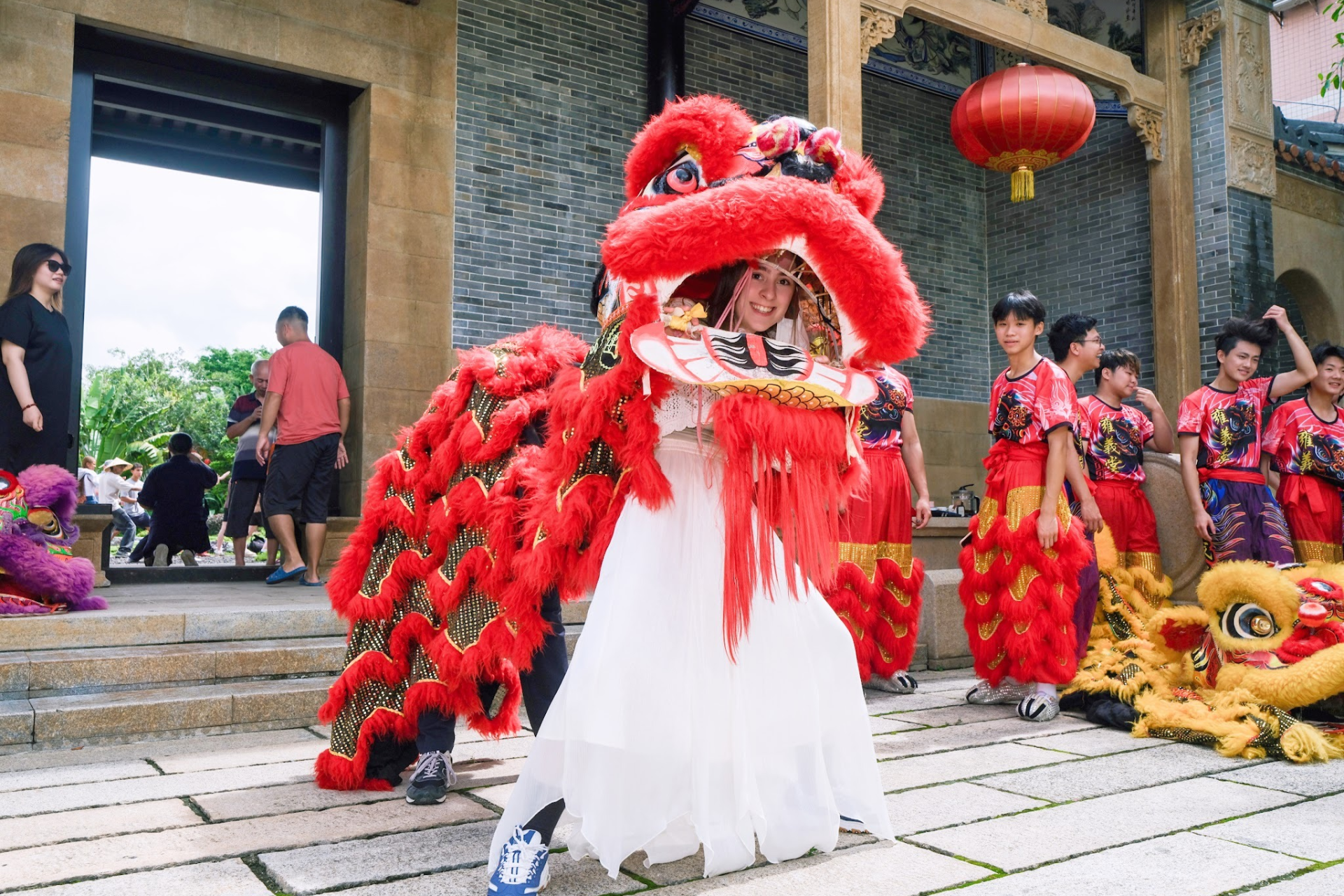 Katie smiling in a Chinese dragon parade costume.