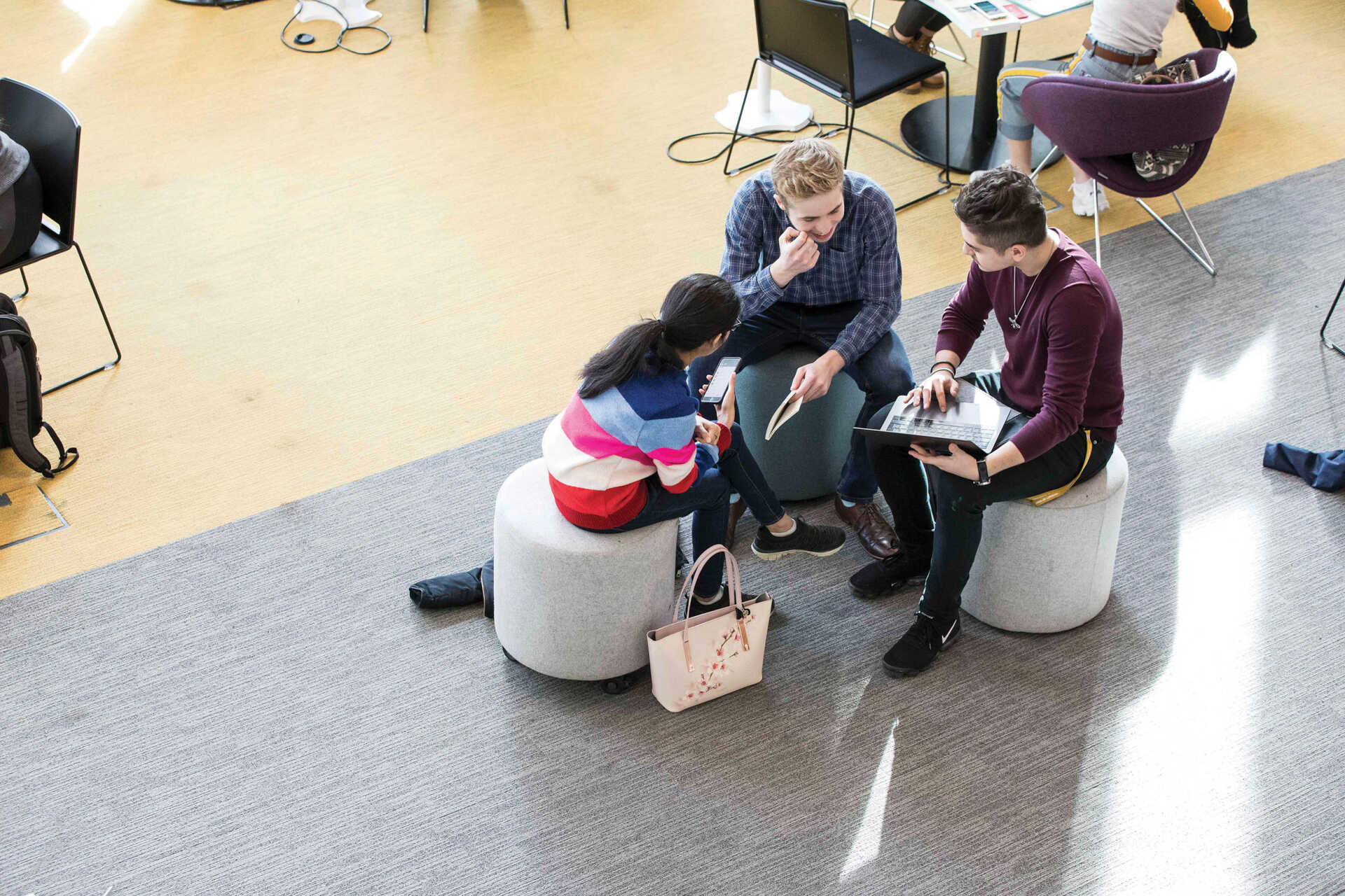 Students discussing work in the library.