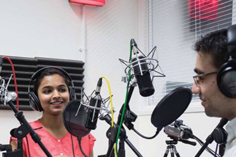 Two students recording in radio studio