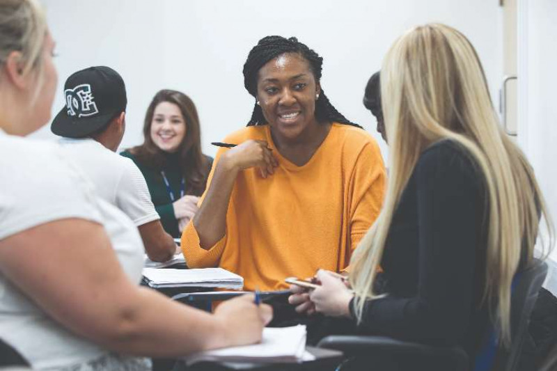 Mixed group of students studying together