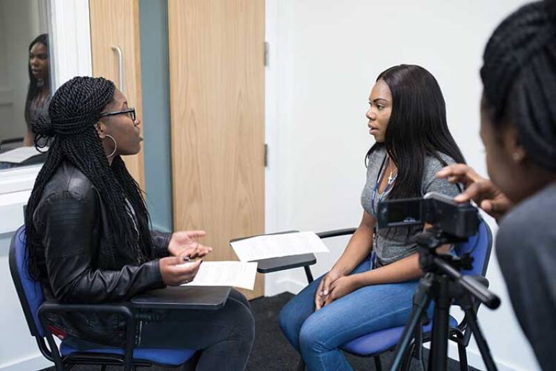 Two social work students being filmed role-playing an interview in one of our consultation rooms