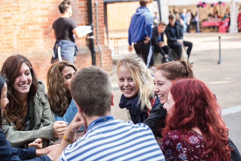 mixed group of students laughing